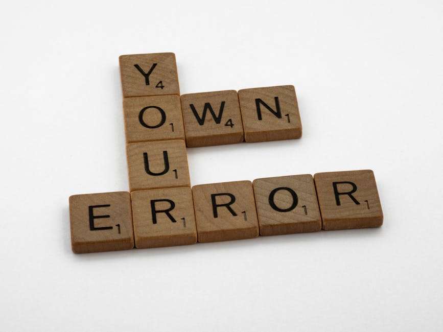 Drewniane płytki do gry w scrabble tworzą słowa "YOUR" oraz "ERROR".