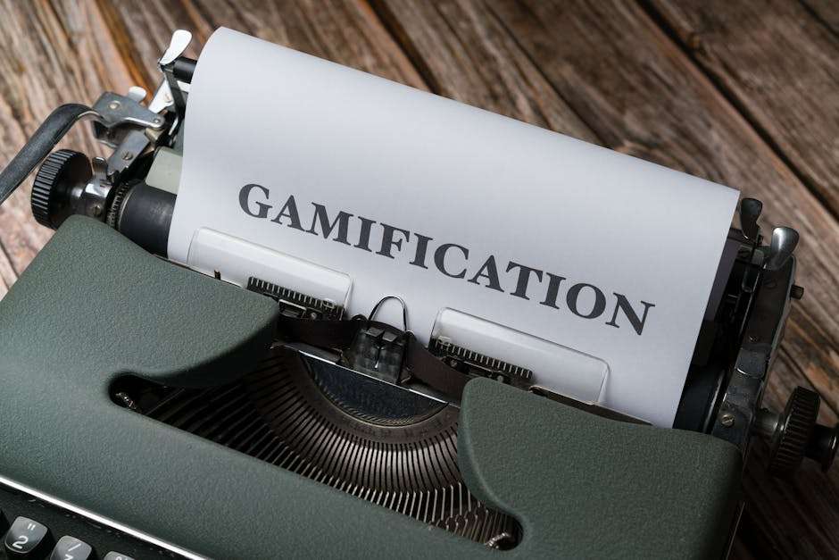Napis „GAMIFICATION” wydrukowany na kartce papieru włożonej do starej maszyny do pisania.